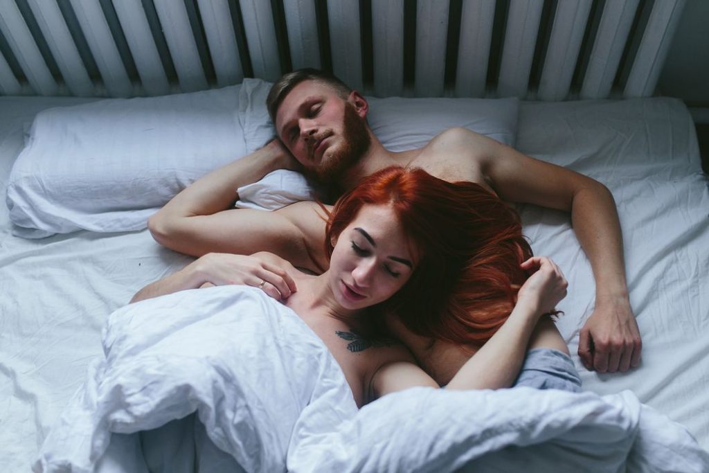 fuckbook couples resting on a bed after having sex